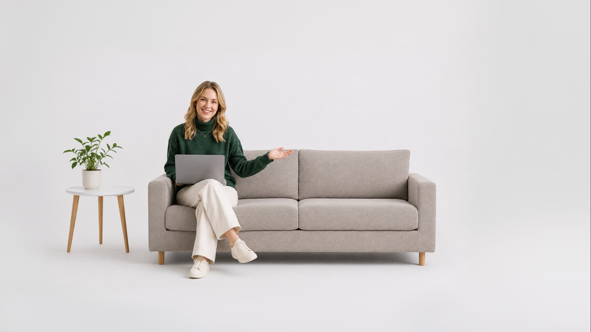 Woman sitting on a sofa with a laptop and presenting