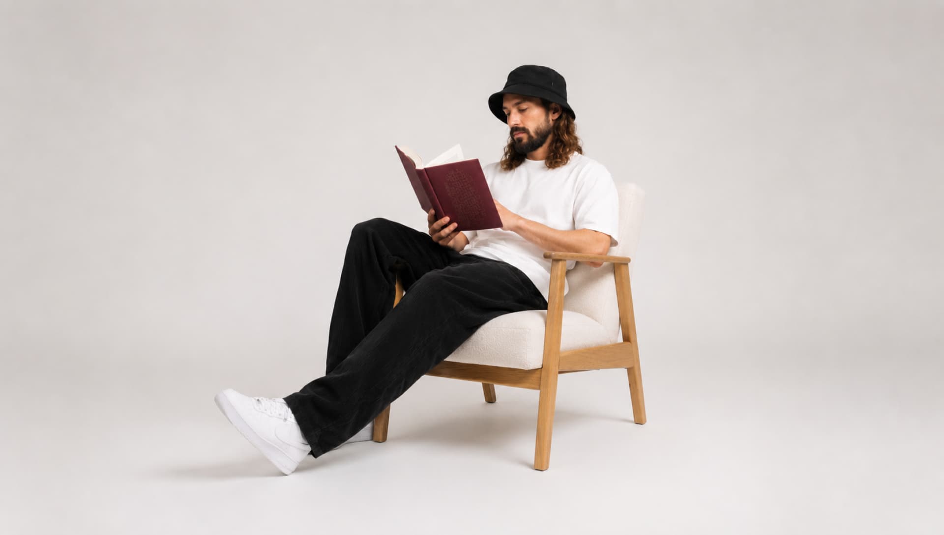 Man sitting in a chair and reading a book